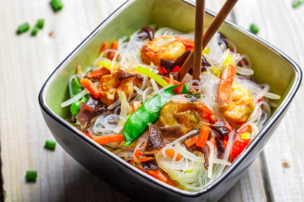 Chinese mix vegetables and rice noodles on old wooden table